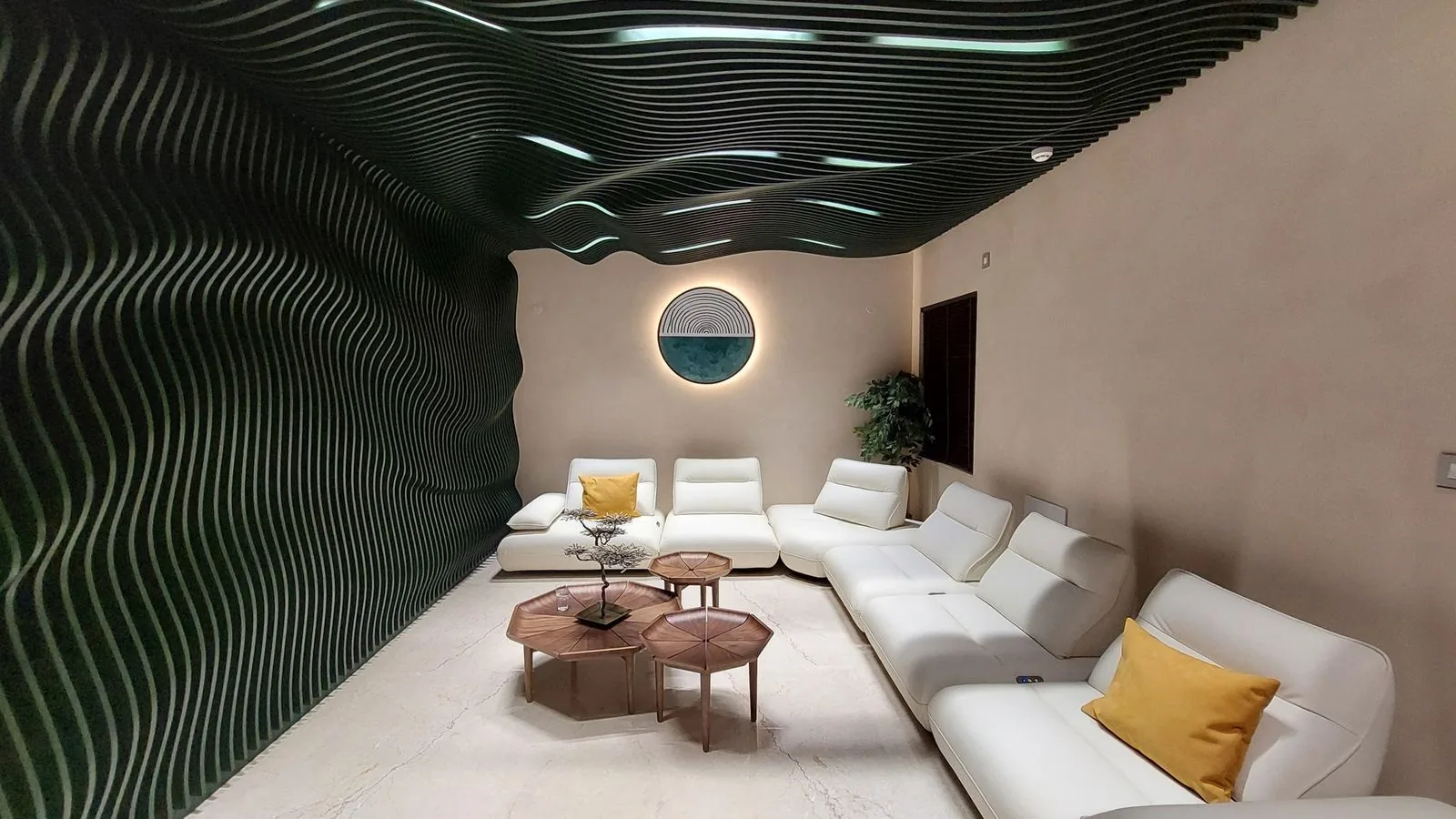 Completed Aparna One interior with flowing green wall and ceiling sections